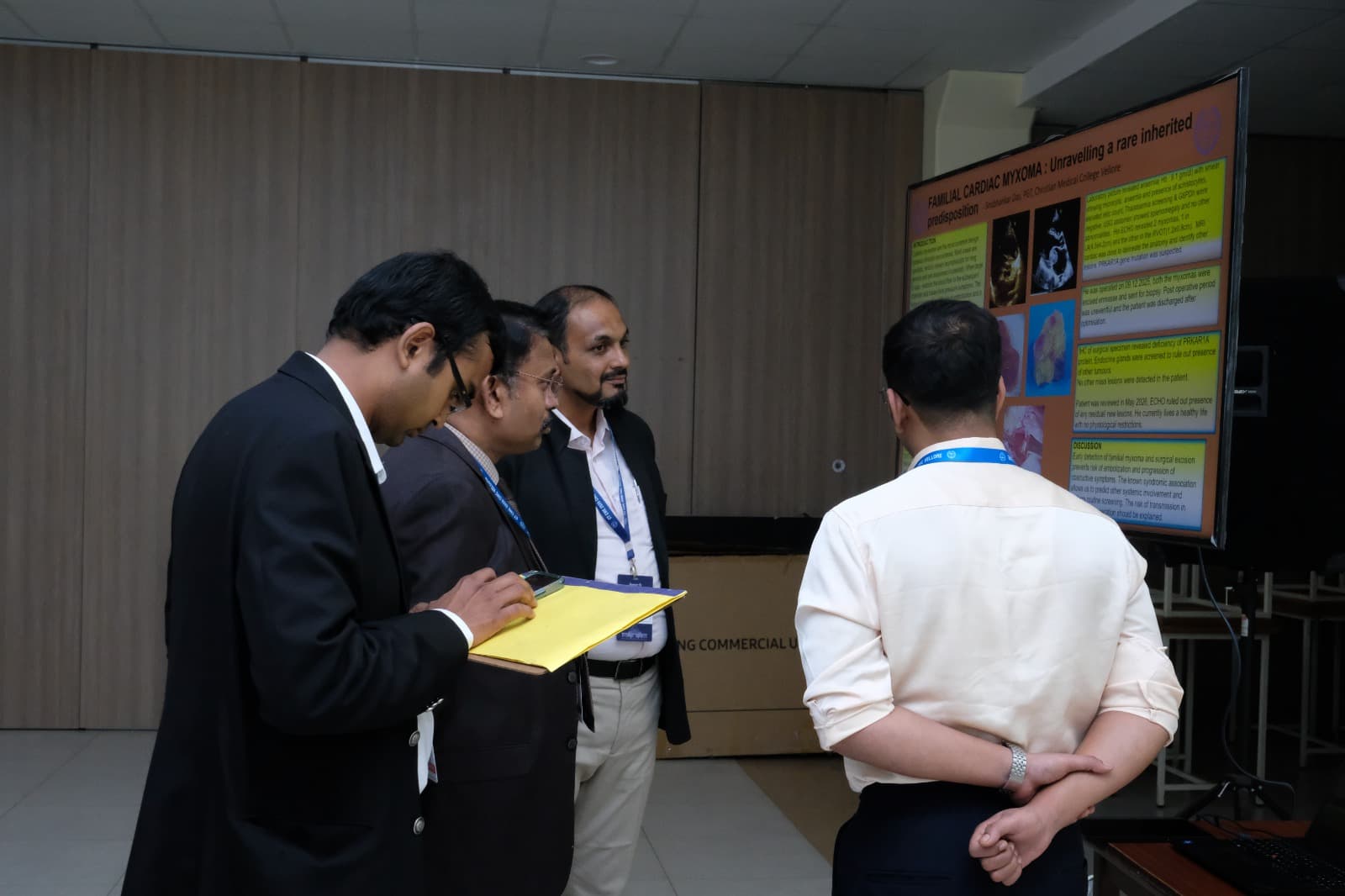 Judges reviewing a research poster presented by a trainee at the IACTS CT CME 2026 poster session